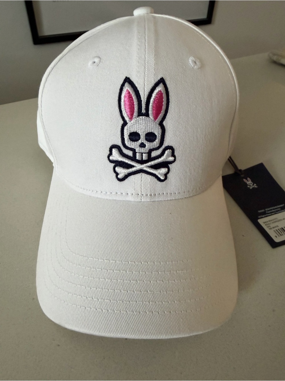 Psycho Bunny White Cap with Pink-Accented Bunny Skull Logo